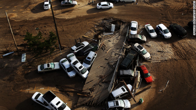 Abandoned and flooded cars are piled up on Friday, November 2, in the heavily damaged Rockaway neighborhood, in Queens, where a large section of a landmark boardwalk was washed away.