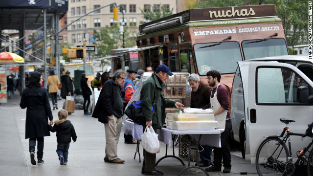 Food trucks and men selling bread and cheeses line Broadway at Union Square on Friday in New York as the city recovers from the effects of Superstorm Sandy.
