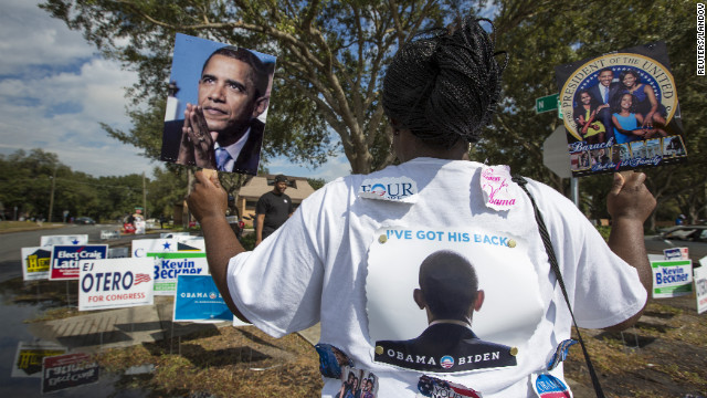 Obama supporter Tonya Lewis rallies for votes outside a polling station in Tampa, Florida.