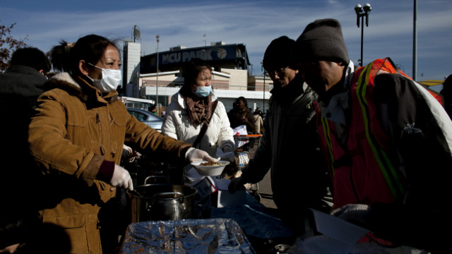 People wait in line for food at a distribution center at Coney Island.