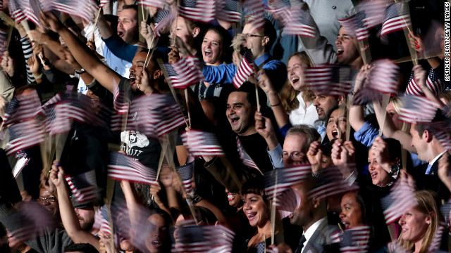 A blur of waving flags greeted President Barack Obama's victory speech at an election night event in Chicago, Illinois.