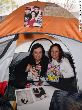 Fans hold up magazines featuring "Twilight" actors Robert Pattinson and Kristen Stewart.