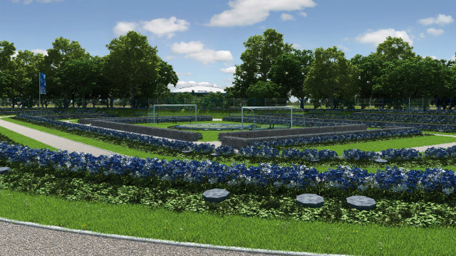 The Schalke Fan Feld, whose centerpiece will be a club logo made up of blue and white flowers lying between two goals, looks directly on to the Bundesliga club's home stadium - the white domed Veltins-Arena, which can be seen in the gap between the trees in this picture. 