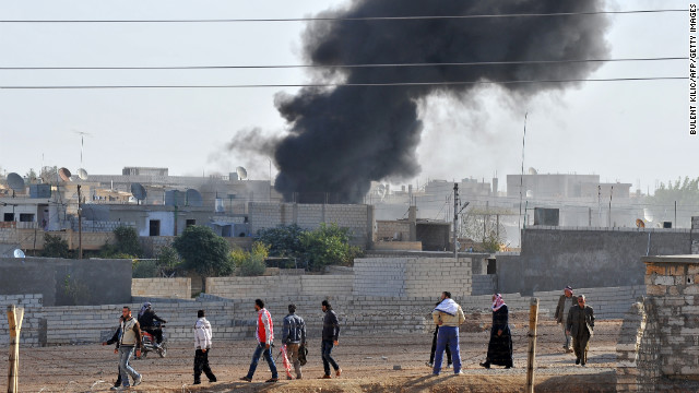 Smoke rises after Syrian aircraft bombed the strategic border town of Ras al-Ain, killing at least four people, wounding many others and sending panicked residents fleeing across to Turkey on Monday, November 12.