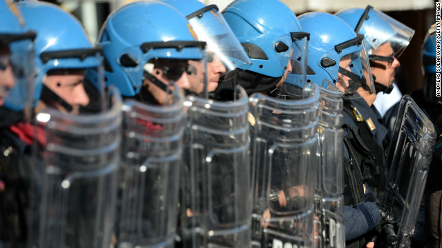 Riot policemen stand in line during a protest against austerity measures by workers in Europe on November 14, 2012 in Rome. 