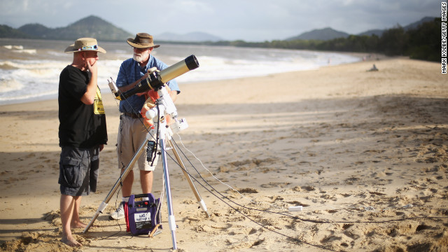 Jonathan Bradshaw and Terry Cuttle set up telescopic cameras and computer equipment on Palm Cove beach in preparation to run a live stream via NASA of the total solar eclipse in Cairns on Tuesday.