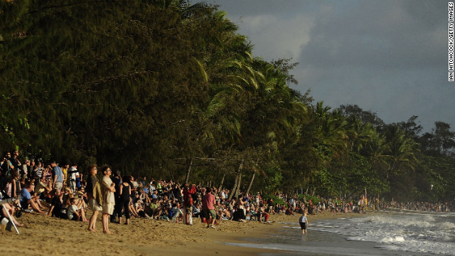 Spectators line the beach to view the total solar eclipse on Wednesday in Palm Cove.