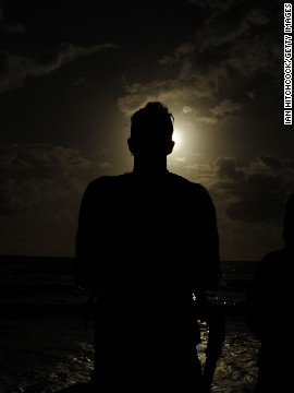 A spectator views the solar eclipse on Wednesday in Palm Cove.