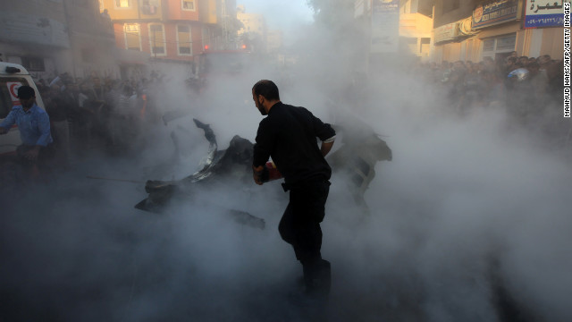 Palestinian firefighters extinguish the blaze from the car of Ahmed al-Jaabari, head of Hamas' military wing, after an Israeli airstrike hit it in Gaza City on Wednesday, November 14. The Israeli strike killed al-Jaabari.