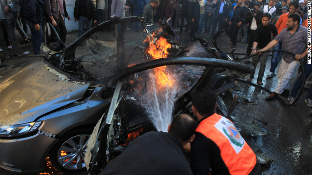 Palestinian firefighters extinguish fire from the car in which al-Jaabari was apparently riding.