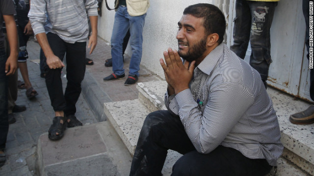 A Palestinian man cries as security forces wheel al-Jaabari's body into a hospital.