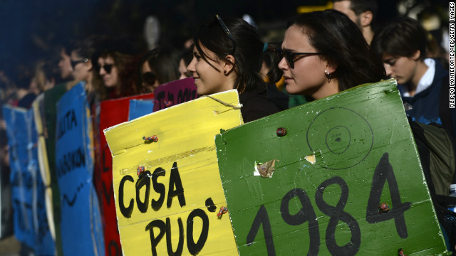 Students hold placards with titles of classic books during a protest on a day of mobilization against austerity measures by workers in southern Europe on November 14, 2012 in Rome.