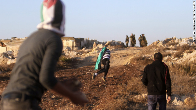Palestinian youths throw stones at Israeli security forces Friday, November 16, in a West Bank village near Bethlehem.