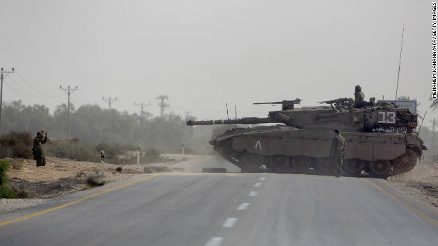 Israeli tanks maneuver at the Israeli-Gaza Strip border.