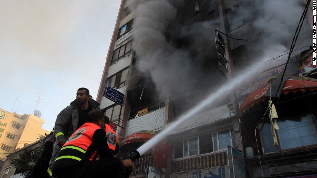 Palestinian firefighters extinguish a blaze following an Israeli airstrike in a Gaza City tower housing Palestinian and international media on Monday.