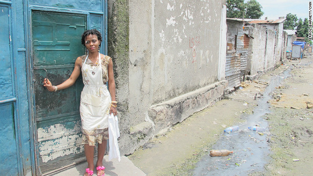 Masamba, like many other members of the orchestra, lives in a typical Kinshasa neighborhood that has unpaved roads and is lined with sewage.