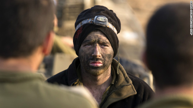 An Israeli soldier from a tank squadron attends a morning briefing at an Israeli army deployment area near the Israel-Gaza Strip border on Monday. 