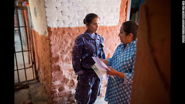 Basnet talks to a female prison guard to gain permission to go inside a jail in Kathmandu. Basnet was studying social work in college when she first visited a women's prison and discovered how many children had to live there.