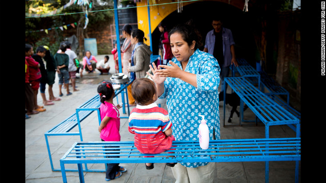 Basnet applies moisturizer cream to one of the children in Kathmandu.