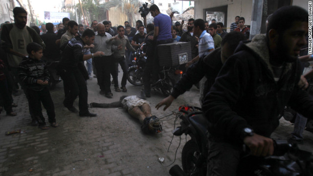 November 20: Men on motorcycles drag the body of a man through the streets of Gaza City. The men dragging the body claimed it was the body of a collaborator and an Israeli spy. Hamas and Israel agreed to a cease-fire on November 21 after eight days of round-the-clock warfare.