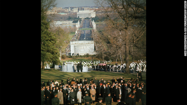 A horse-drawn caisson bears the body of President John F. Kennedy into Arlington National Cemetery.