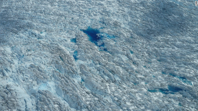 Meltwater ponds below indicate surface melt during the arctic summer. 