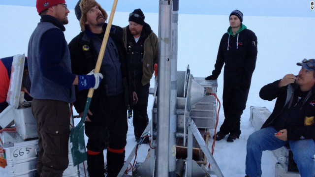 Scientists work the ice core drill in the middle of the inland ice.