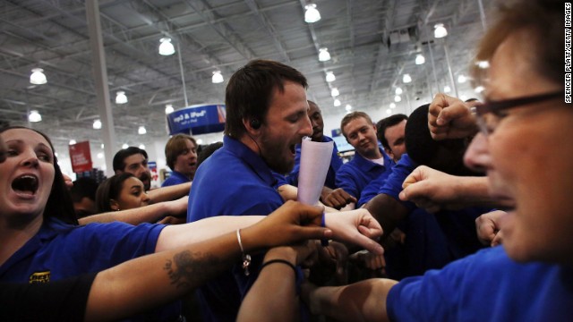 Best Buy employees have a group huddle before they open the store in Naples, Florida.