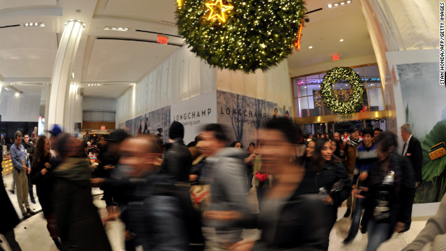 Shoppers rush into Macy's in New York at midnight.