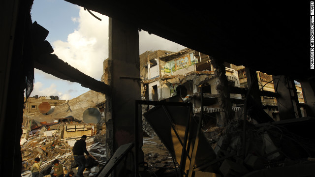 Palestinians inspect the rubble of a destroyed house in Gaza City on Friday.
