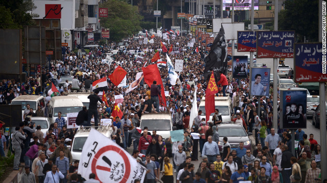 Thousands of demonstrators march through the streets of Cairo to protest against Morsy on Friday.