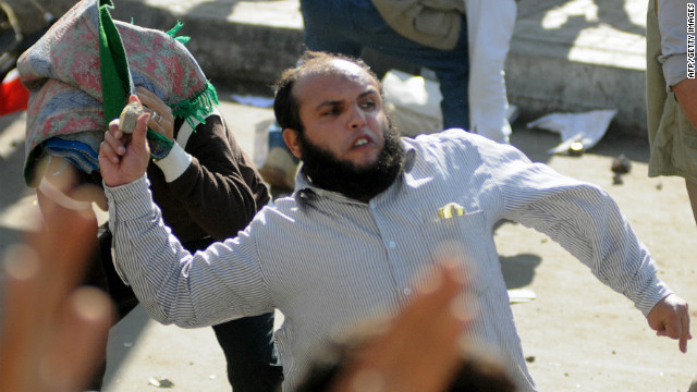 A man throws a rock during clashes in Alexandria on Friday.