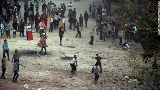 Egyptian protesters throw rocks toward riot police on Friday