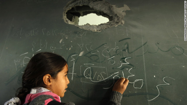 A Palestinian schoolgirl writes on the blackboard of a classroom in Gaza City on Saturday.