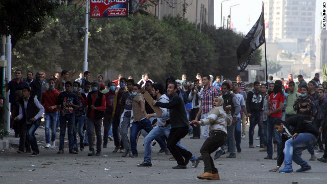 Egyptian protesters hurl stones at police at Tahrir Square on Sunday.