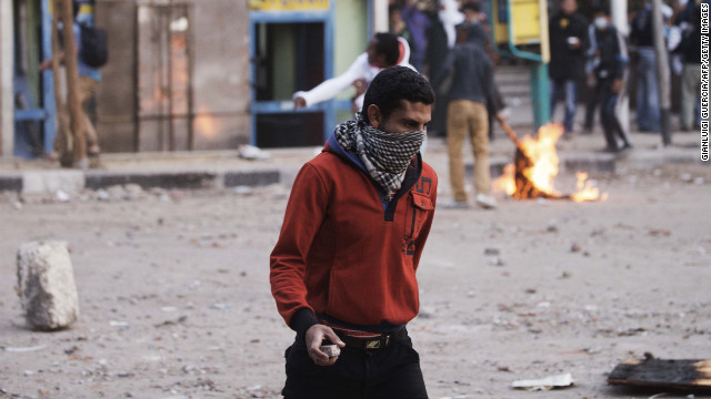 A protester carries a rock during clashes with police on Wednesday.