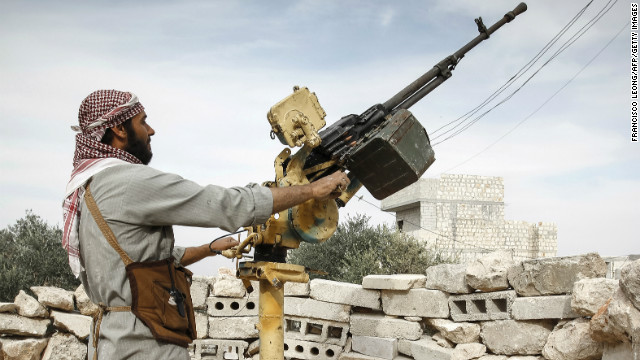 A Syrian rebel mans a Dska heavy machine gun as he scans the skies for Syrian air force fighter jets in Maarat al-Numan.