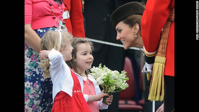 Catherine speaks with two young girls as she presents shamrocks to members of the 1st Battalion Irish Guards at the St Patrick's Day Parade on March 17, 2012, at Mons Barracks in Aldershot.