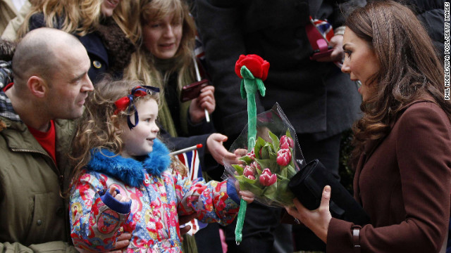A young girl offers Catherine a toy rose as the Duchess visits Alder Hey Children's Hospital on February 14, 2012, in Liverpool, England. Interacting with children during visits to hospital or charities is a part of official duties that Catherine seems to enjoy.