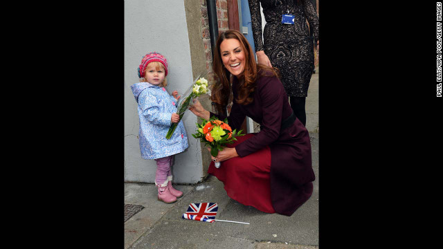 Catherine laughs as she receives flowers from 2-year-old Lola Mackay, who refused to let go of them, during a visit to the CRI Stockton Recovery Service on October 10, 2012, in Stockton-on-Tees, England.
