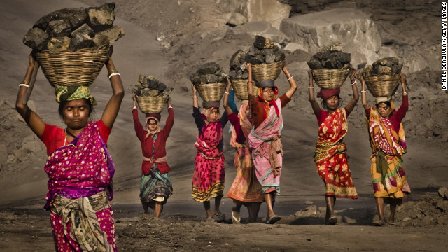 February 11: Villagers carry coal scavenged illegally from an open-cast coal mine in the village of Jina Gora, India. Claiming that a decades-old underground coal fire threatened the homes of villagers, the government relocated more than 2,300 families.