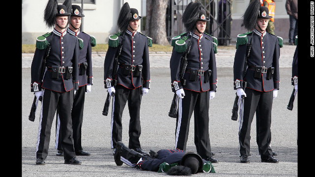 March 20: A soldier faints as Camilla, Duchess of Cornwall, and Prince Charles, Prince of Wales, arrive for a wreath-laying ceremony at the National Monument at Akershus Fortress in Olso, Norway. The royals were on a Diamond Jubilee tour of Scandinavia.