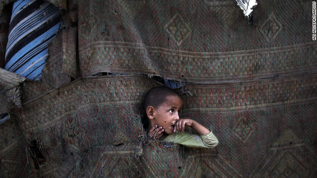 July 22: A Palestinian refugee plays in between makeshift tents in the Al-Zaiton neighborhood before breaking fast on the third day of the holy month of Ramadan in Gaza. During Ramadan, Muslims fast from dawn to dusk. 