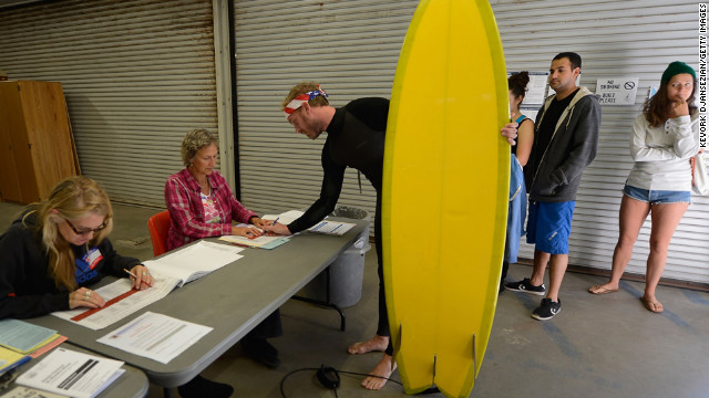 November 6: Mike Wigart picks up his ballot at a polling station in the garage of the Los Angeles County lifeguard headquarters. Americans headed to the polls to vote in the race between President Barack Obama and Republican candidate Mitt Romney. 