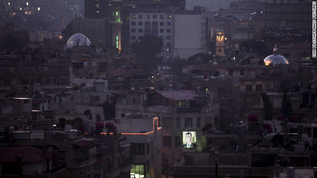 January 26: An illuminated portrait of Syrian President Bashar al-Assad shines out as dusk settles over Damascus. About 40,000 civilians have been killed since the first protests began in March 2011 against al-Assad's government, according to the opposition Center for Documentation of Violations in Syria.