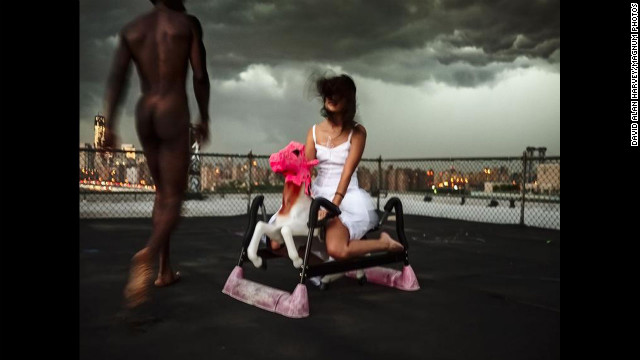 Sometime in July: Magnum photographer David Alan Harvey's assistant sits on a rocking horse at his apartment on the water in Brooklyn, New York, for this fine-art photograph, "White Horse No. 2."