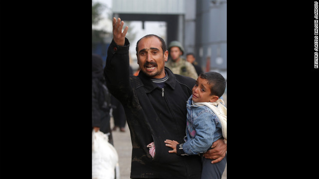 Syrians cross the border from Ras al-Ain, Syria, to the Turkish border town of Ceylanpinar on Tuesday, December 4. Syrian warplanes dropped two bombs on the town, causing panicked and injured people to try and flee to Turkey, witnesses told CNN. 