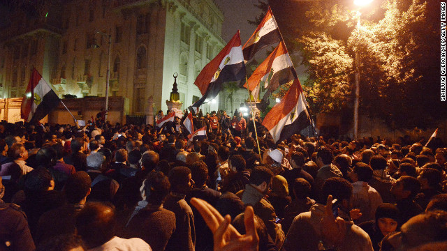 Tens of thousands of demonstrators encircled the presidential palace in Cairo after riot police failed to keep them at bay with tear gas on December 4.