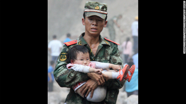 September 9: A rescue worker carries a child in Yiliang County, China. At least 80 people were killed and more than 800 others were injured after two earthquakes jolted southwest China.