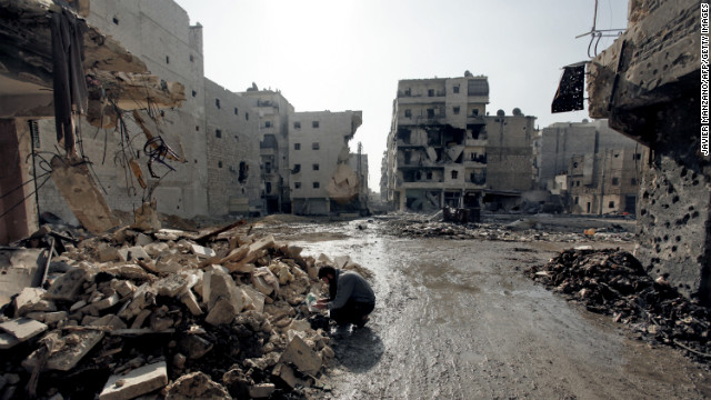 A man inspects rubble in a neighborhood of Aleppo on Sunday, December 2.